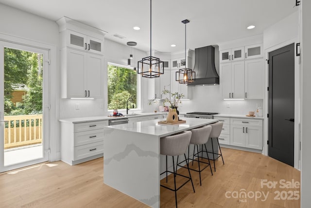 3937 Plainview Rd, Charlotte, NC 28208 - kitchen featuring premium range hood, healthy amount of natural light, white cabinets, a center island, and recessed lighting