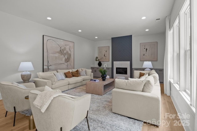 3937 Plainview Rd, Charlotte, NC 28208 - living area featuring light wood-style floors, plenty of natural light, recessed lighting, and a large fireplace