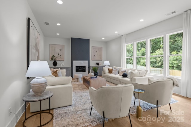 3937 Plainview Rd, Charlotte, NC 28208 - living room featuring recessed lighting, wood finished floors, and a high end fireplace
