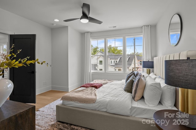 3937 Plainview Rd, Charlotte, NC 28208 - bedroom with wood finished floors, multiple windows, ceiling fan, and recessed lighting