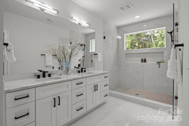 3937 Plainview Rd, Charlotte, NC 28208 - bathroom featuring marble look tiles, double vanity, and a marble finish shower
