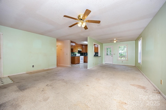 38367 Loblolly Ln, New London, NC 28127 - unfurnished living room featuring ceiling fan, light carpet, and a textured ceiling
