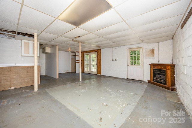 38367 Loblolly Ln, New London, NC 28127 - basement with concrete block wall, a paneled ceiling, a fireplace, and french doors