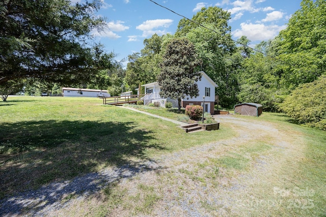 38367 Loblolly Ln, New London, NC 28127 - view of green lawn featuring a storage shed