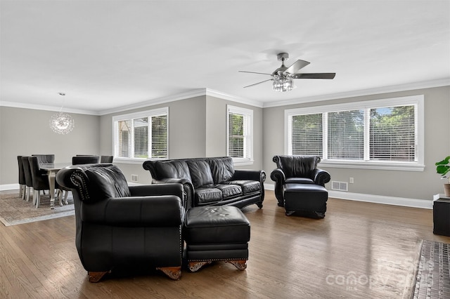 3127 N Center St, Hickory, NC 28601 - living room featuring wood finished floors, a chandelier, a ceiling fan, and ornamental molding