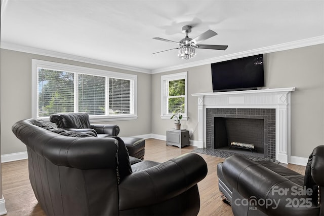 3127 N Center St, Hickory, NC 28601 - living area featuring a tile fireplace, a ceiling fan, ornamental molding, and wood finished floors
