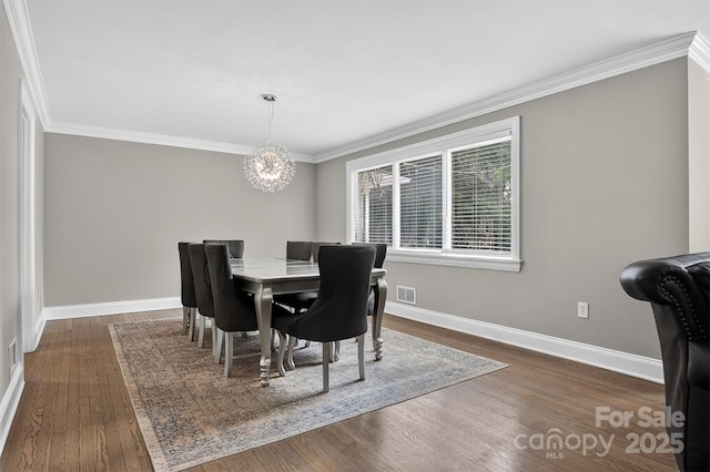 3127 N Center St, Hickory, NC 28601 - dining room featuring a chandelier, crown molding, and dark wood-style floors
