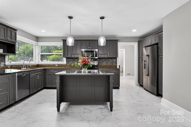 3127 N Center St, Hickory, NC 28601 - kitchen featuring stainless steel appliances, light marble finish flooring, dark countertops, backsplash, and recessed lighting
