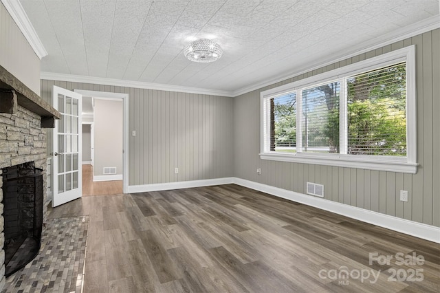 3127 N Center St, Hickory, NC 28601 - unfurnished living room featuring crown molding, dark wood-style flooring, and a stone fireplace