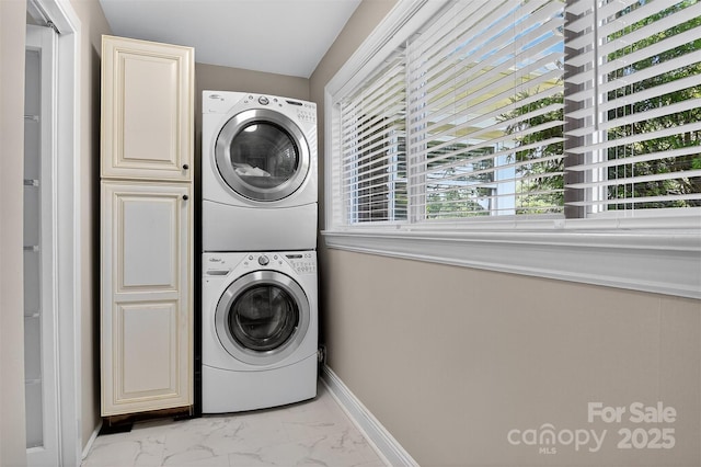 3127 N Center St, Hickory, NC 28601 - washroom with cabinet space, stacked washer and clothes dryer, and light marble finish flooring