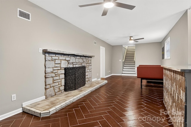 3127 N Center St, Hickory, NC 28601 - unfurnished living room with ceiling fan, stairs, and a fireplace