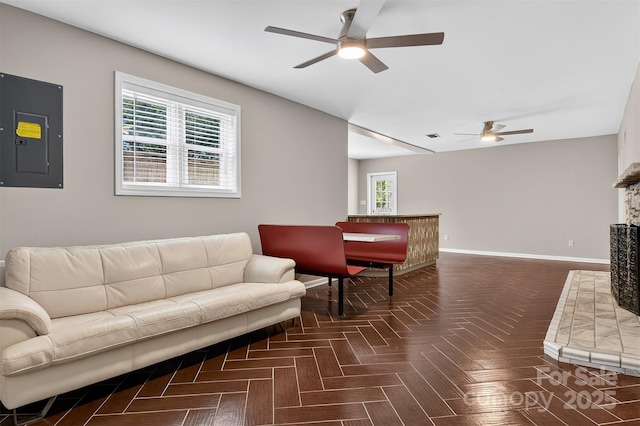 3127 N Center St, Hickory, NC 28601 - living area featuring a ceiling fan, electric panel, and a fireplace with raised hearth