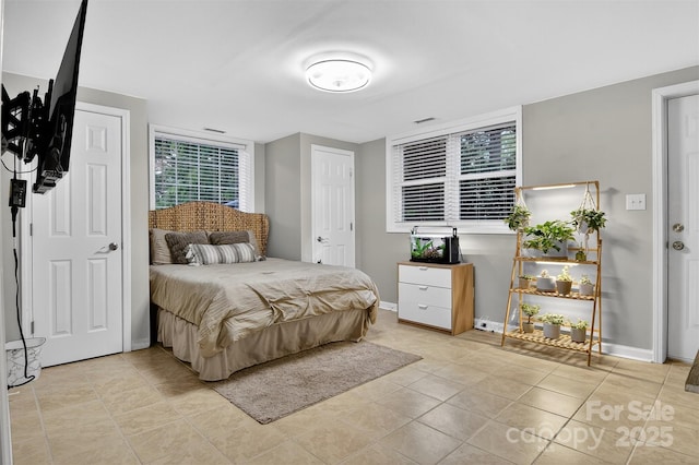 3127 N Center St, Hickory, NC 28601 - bedroom with baseboards and light tile patterned flooring