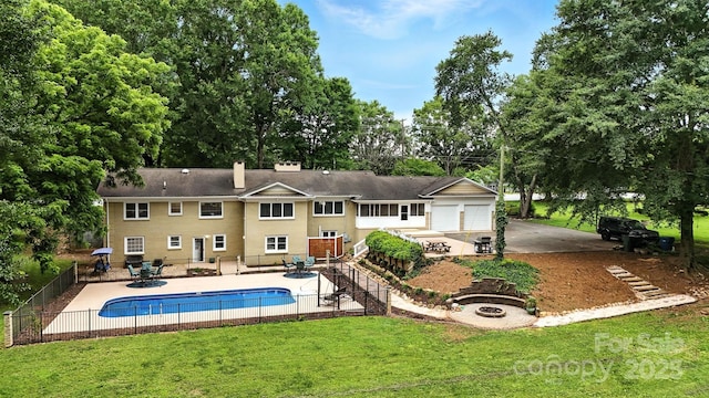 3127 N Center St, Hickory, NC 28601 - back of property with an outdoor fire pit, a patio, view of wooded area, and driveway