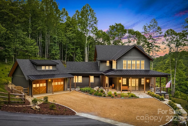 1416 E Clubhouse Rd Unit 73, Sylva, NC 28779 - view of front of home with a standing seam roof, dirt driveway, a porch, and a metal roof