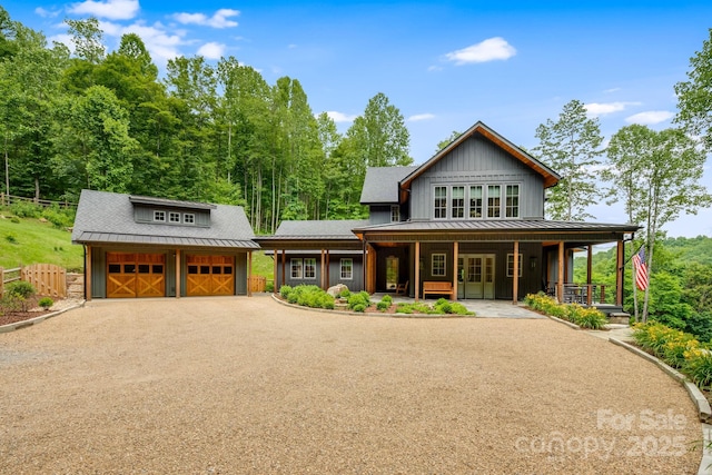 1416 E Clubhouse Rd Unit 73, Sylva, NC 28779 - view of front of house with board and batten siding, an outdoor structure, a porch, dirt driveway, and a metal roof