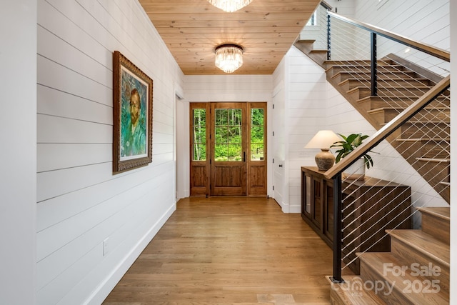 1416 E Clubhouse Rd Unit 73, Sylva, NC 28779 - foyer featuring stairs, wood finished floors, wood walls, and a chandelier