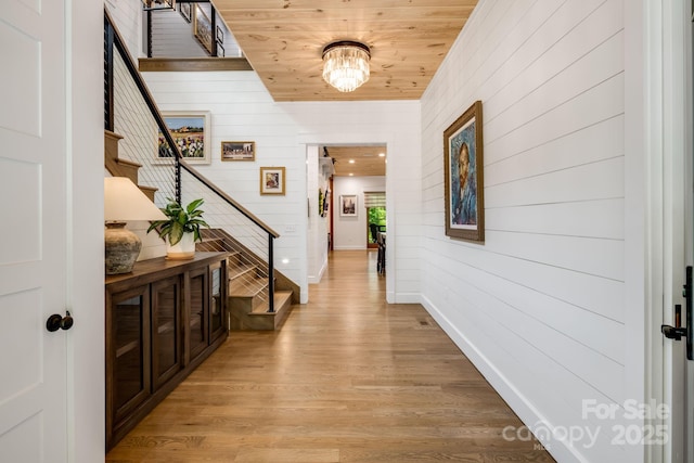 1416 E Clubhouse Rd Unit 73, Sylva, NC 28779 - corridor with light wood finished floors, wood walls, stairway, wood ceiling, and a chandelier