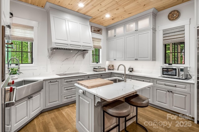 1416 E Clubhouse Rd Unit 73, Sylva, NC 28779 - kitchen featuring wooden ceiling, black electric stovetop, recessed lighting, stainless steel microwave, and a center island with sink