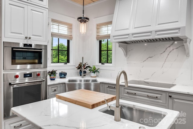 1416 E Clubhouse Rd Unit 73, Sylva, NC 28779 - kitchen featuring black electric stovetop, stainless steel double oven, tasteful backsplash, and white cabinetry