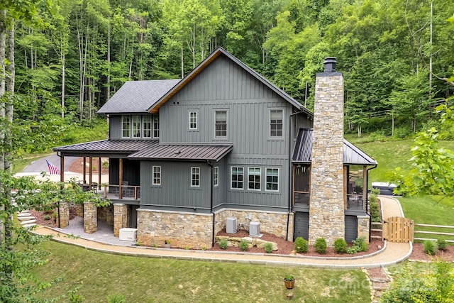 1416 E Clubhouse Rd Unit 73, Sylva, NC 28779 - back of house featuring a standing seam roof, a forest view, a chimney, board and batten siding, and a metal roof