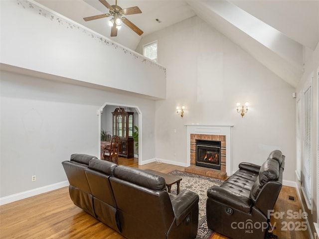 30 Collenwood Rd, Arden, NC 28704 - living room with high vaulted ceiling, a ceiling fan, arched walkways, light wood finished floors, and a brick fireplace