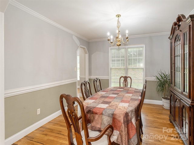 30 Collenwood Rd, Arden, NC 28704 - dining area with a chandelier, light wood-style floors, ornamental molding, and arched walkways