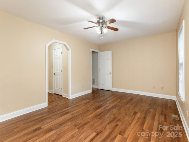 30 Collenwood Rd, Arden, NC 28704 - empty room featuring wood finished floors, ceiling fan, and arched walkways