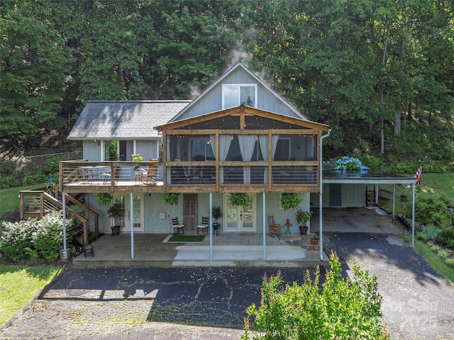 1411 Kitchens Branch Rd, Sylva, NC 28779 - rear view of house with driveway, a deck, french doors, a carport, and stairway