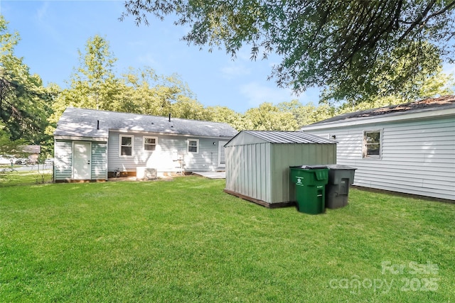 835 Carrington Dr, Charlotte, NC 28214 - back of house featuring a storage unit and a lawn