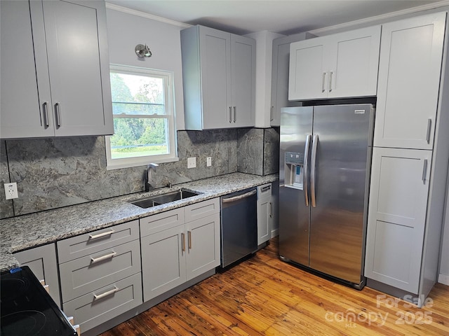 1704 16th St NE, Hickory, NC 28601 - kitchen featuring stainless steel appliances, light stone countertops, decorative backsplash, light wood-style floors, and crown molding