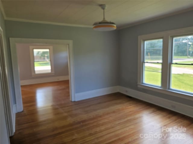 1704 16th St NE, Hickory, NC 28601 - unfurnished room featuring ornamental molding, plenty of natural light, and wood finished floors