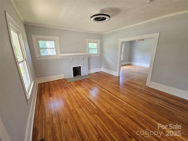 1704 16th St NE, Hickory, NC 28601 - unfurnished living room with crown molding, hardwood / wood-style flooring, and a brick fireplace