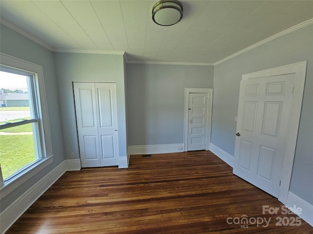 1704 16th St NE, Hickory, NC 28601 - unfurnished bedroom featuring dark wood-style flooring, a closet, and crown molding