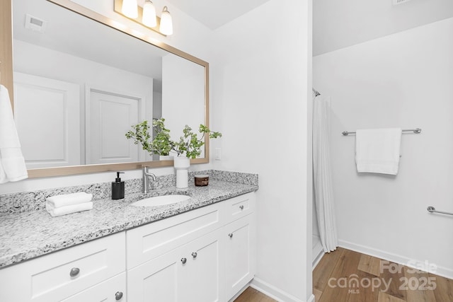 4474 Pebblebrook Cir SW, Concord, NC 28027 - bathroom featuring vanity, wood finished floors, and a shower with curtain