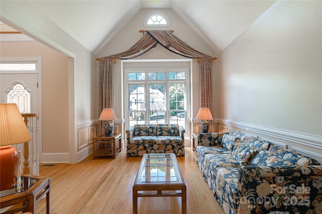 10405 Lady Grace Ln, Charlotte, NC 28270 - living room featuring a wainscoted wall, vaulted ceiling, healthy amount of natural light, light wood-style floors, and a decorative wall