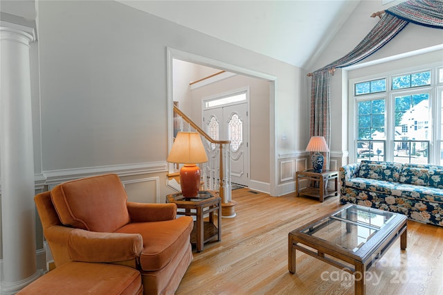 10405 Lady Grace Ln, Charlotte, NC 28270 - living room with ornate columns, a decorative wall, wainscoting, light wood finished floors, and vaulted ceiling
