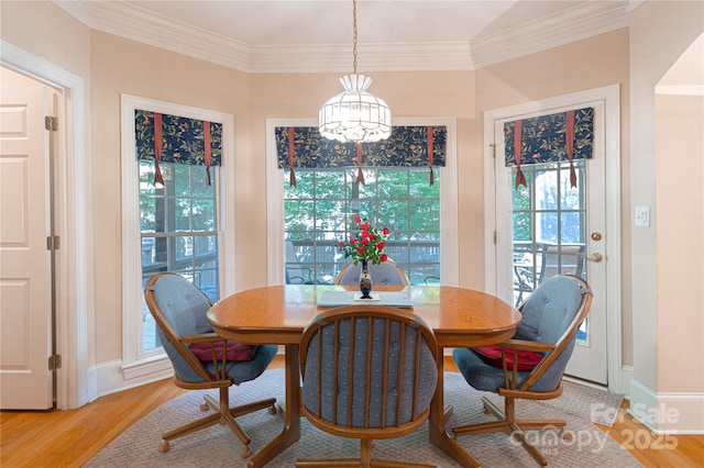 10405 Lady Grace Ln, Charlotte, NC 28270 - dining space featuring a chandelier, light wood-style floors, healthy amount of natural light, and crown molding