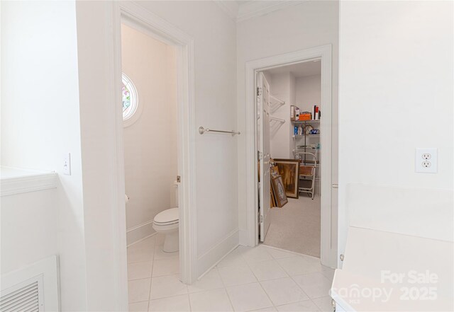 10405 Lady Grace Ln, Charlotte, NC 28270 - bathroom featuring tile patterned floors, a walk in closet, and ornamental molding