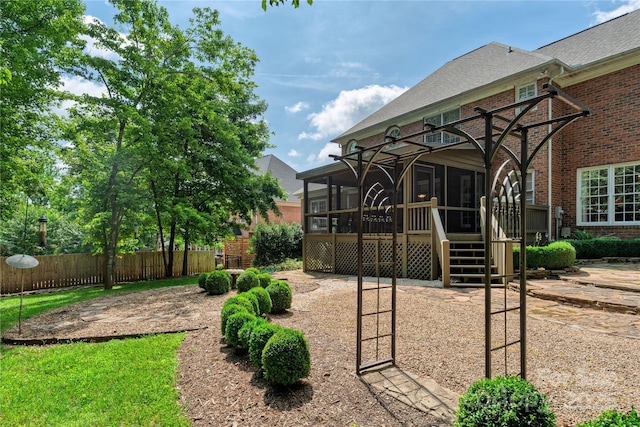 10405 Lady Grace Ln, Charlotte, NC 28270 - rear view of house with a sunroom, brick siding, and roof with shingles