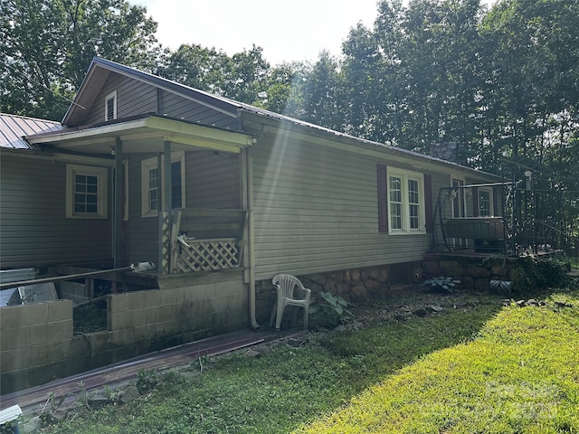 1041 Tomlinson Loop, Connelly Springs, NC 28612 - view of property exterior featuring a yard, a metal roof, and a porch