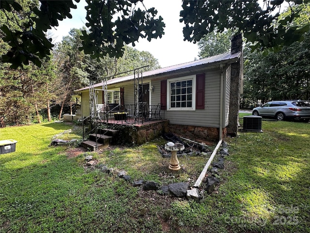 1041 Tomlinson Loop, Connelly Springs, NC 28612 - view of front of house featuring a front lawn, a metal roof, and a chimney