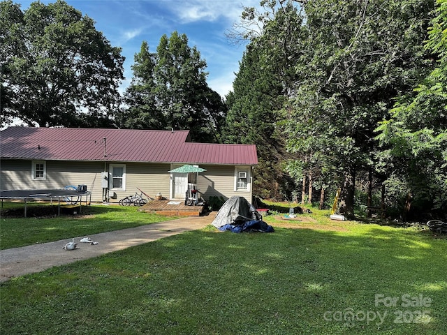 1041 Tomlinson Loop, Connelly Springs, NC 28612 - view of grassy yard with a trampoline