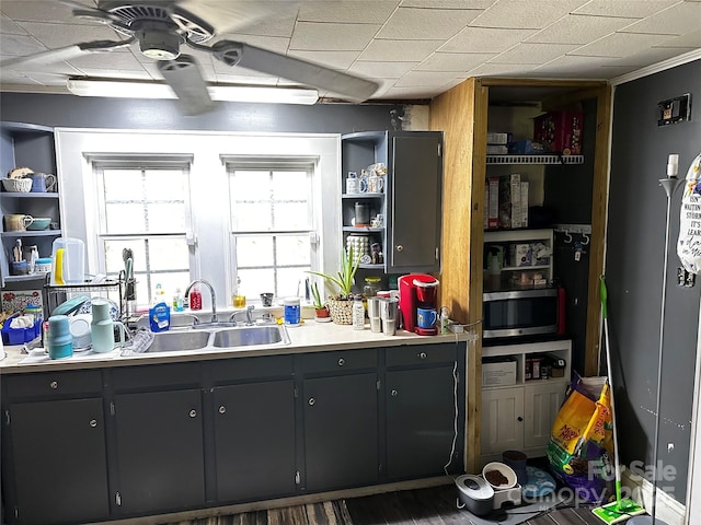 1041 Tomlinson Loop, Connelly Springs, NC 28612 - kitchen with open shelves, stainless steel microwave, light countertops, and wood finished floors