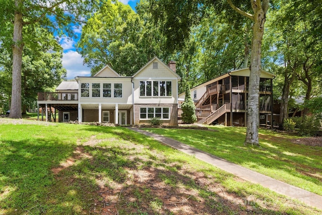 698 Normandy Rd, Mooresville, NC 28117 - rear view of property featuring stairway, a sunroom, a wooden deck, a yard, and a chimney