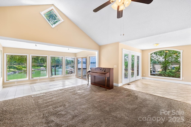 698 Normandy Rd, Mooresville, NC 28117 - unfurnished living room featuring tile patterned flooring, healthy amount of natural light, high vaulted ceiling, a ceiling fan, and french doors