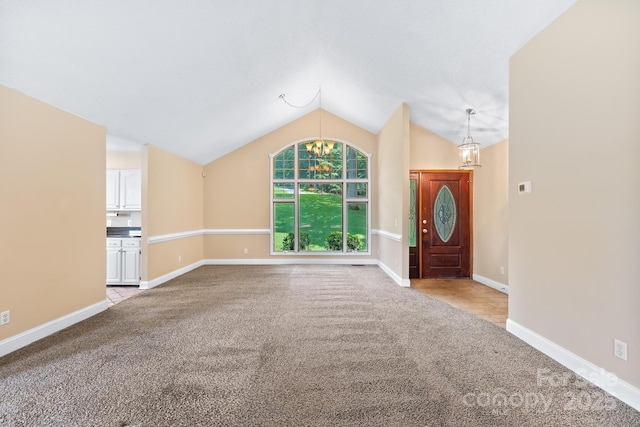 698 Normandy Rd, Mooresville, NC 28117 - unfurnished living room with a chandelier, carpet flooring, and vaulted ceiling