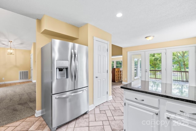 698 Normandy Rd, Mooresville, NC 28117 - kitchen with stainless steel fridge, white cabinets, dark stone countertops, and recessed lighting