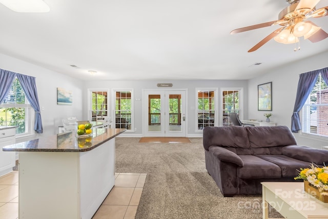 698 Normandy Rd, Mooresville, NC 28117 - living room featuring healthy amount of natural light, light tile patterned flooring, and a ceiling fan