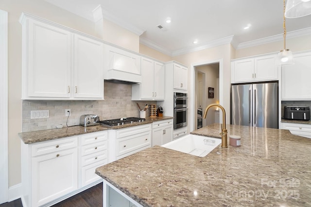 101 Cross Current Ln, Belmont, NC 28012 - kitchen featuring stainless steel appliances, crown molding, white cabinets, tasteful backsplash, and light stone countertops